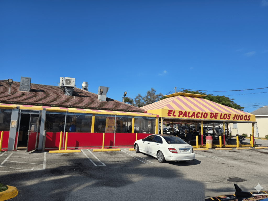 El Palacio de los Jugos at Flager Street. Open-air dining area under yellow and red striped awning.